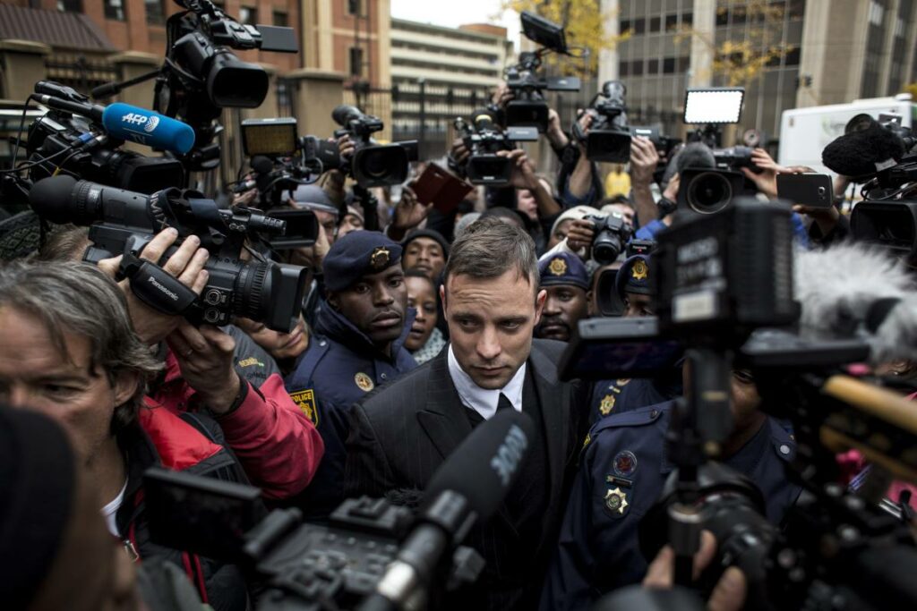 Oscar Pistorius surrounded by reporters